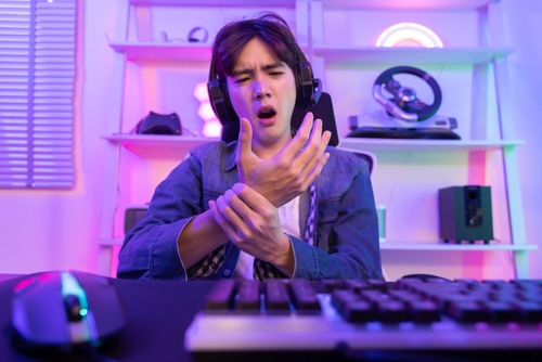 Asian,Esport,Gamer,Grab,His,Wrist,With,Pain,After,Playing